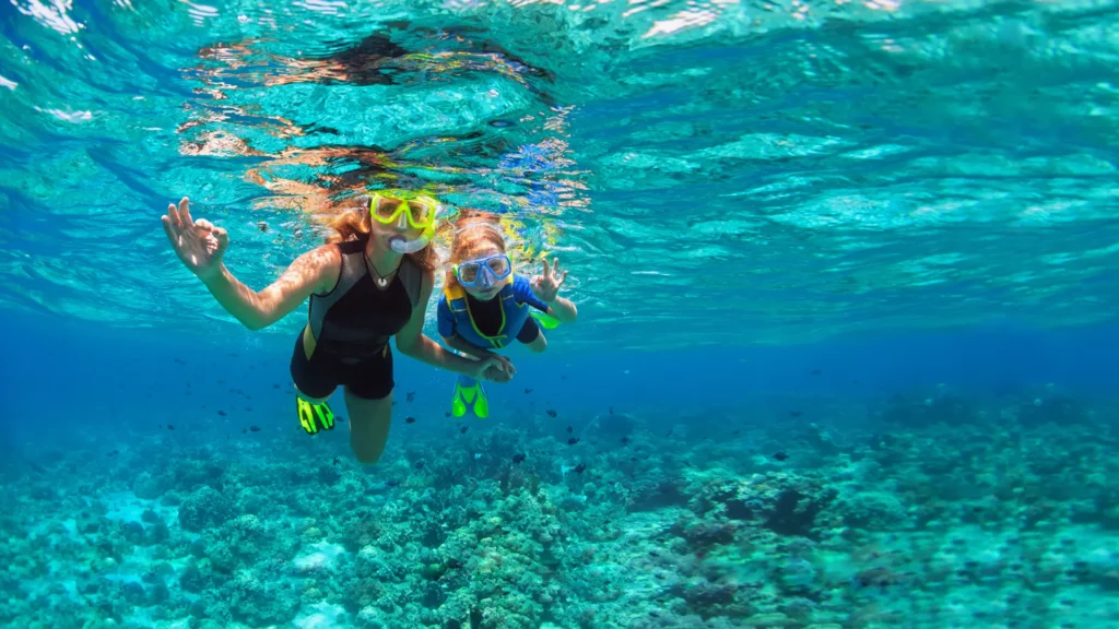 a woman and a kid snorkeling