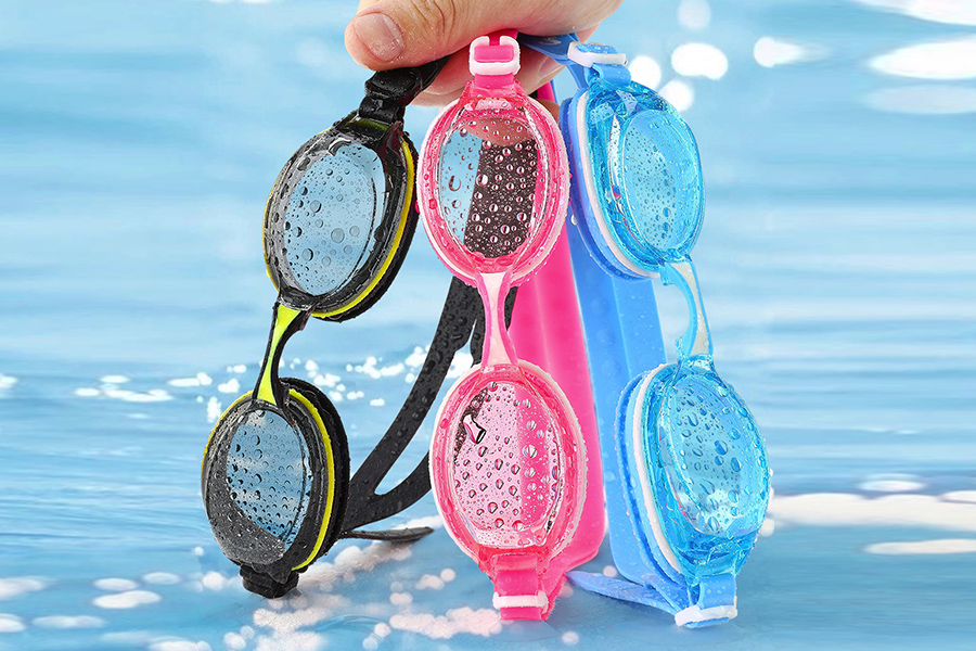 black, pink and blue swimming goggles