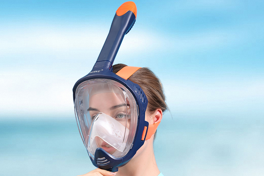 a woman wearing full face snorkel mask