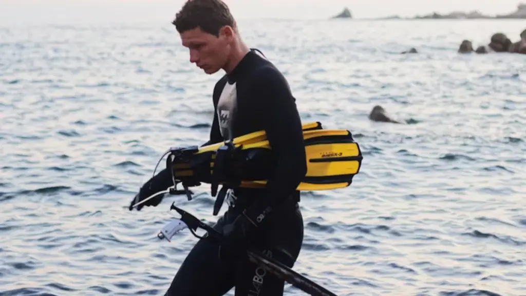 a man carring the diving gear