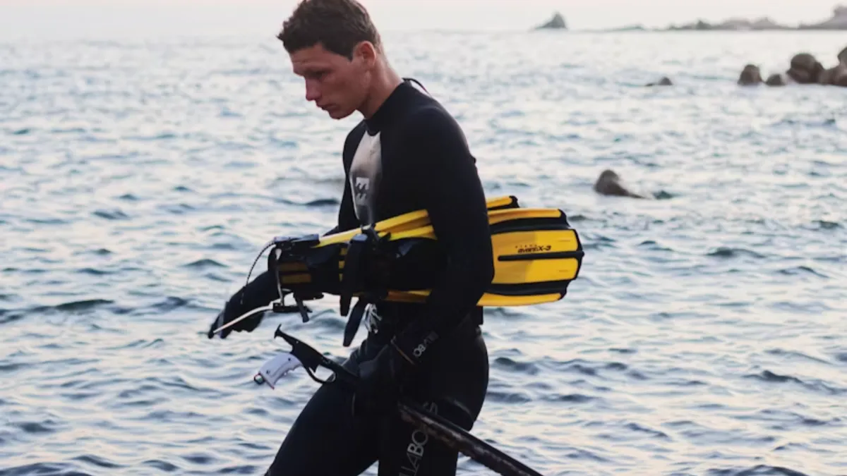 a man carring the diving gear