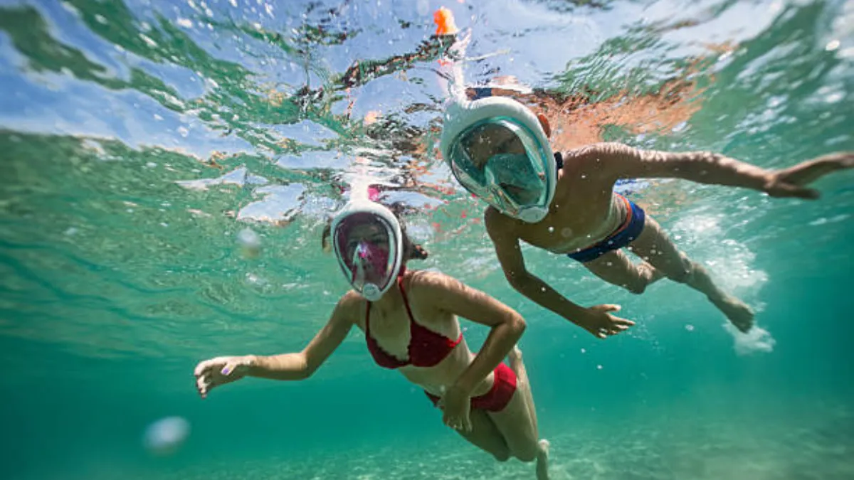 A boy and a girl diving under the sea