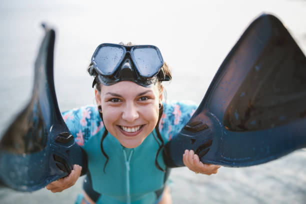 Portrait of happy free diving woman in water.