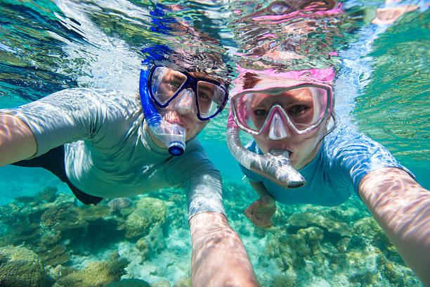 Underwater photo of a couple snorkelling in ocean